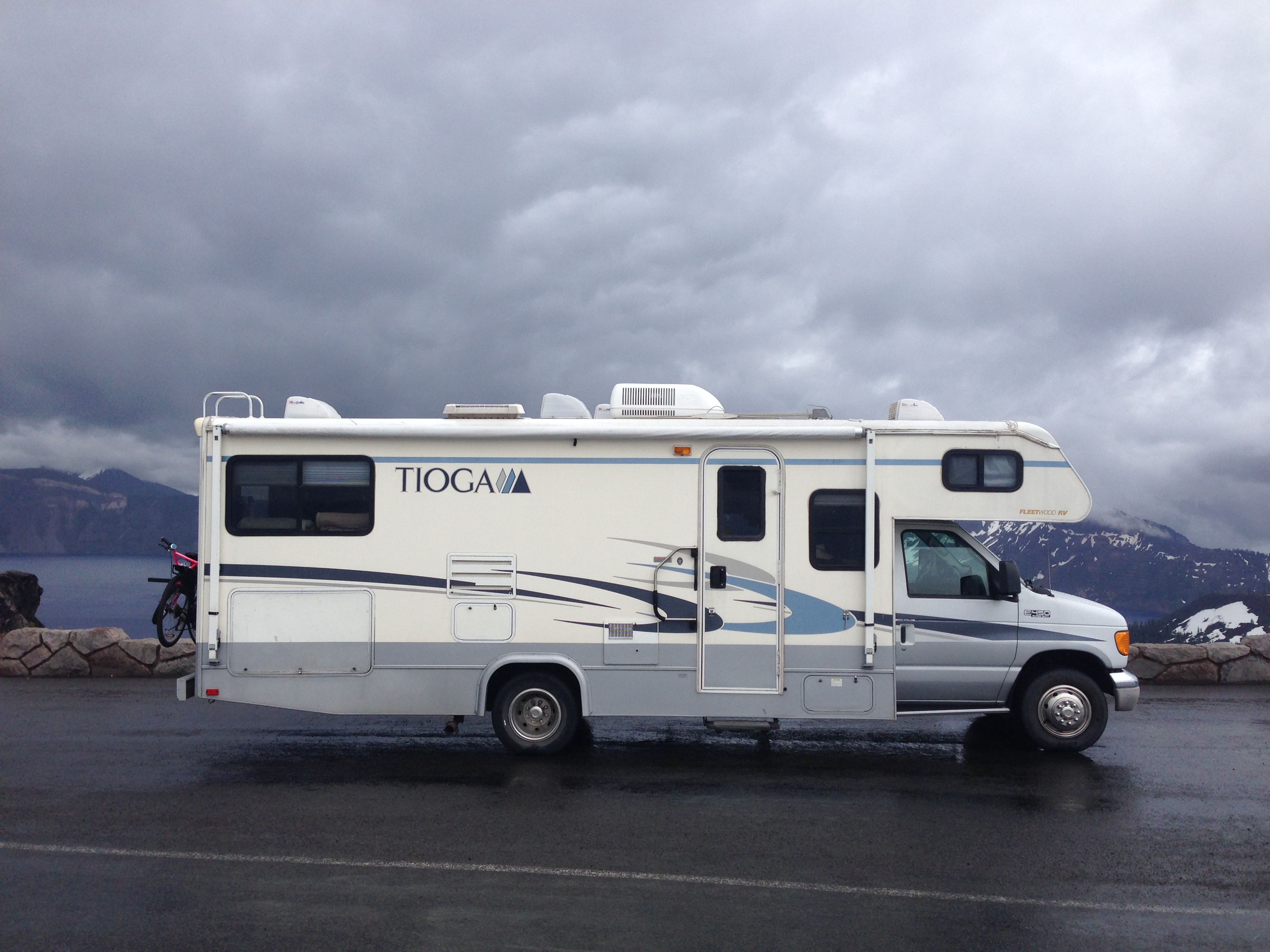 The Tioga parked against a dramatic mountain sky.